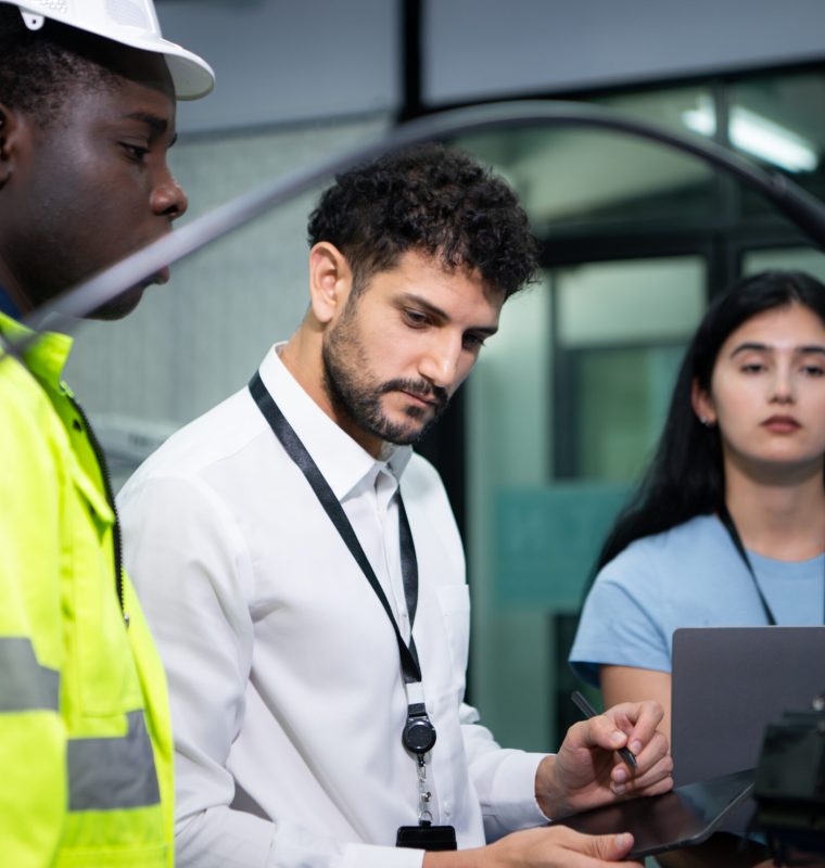 Technicians are introducing industrial hand robots to businessperson of factory industry who will use them in large-scale complex manufacturing operations.